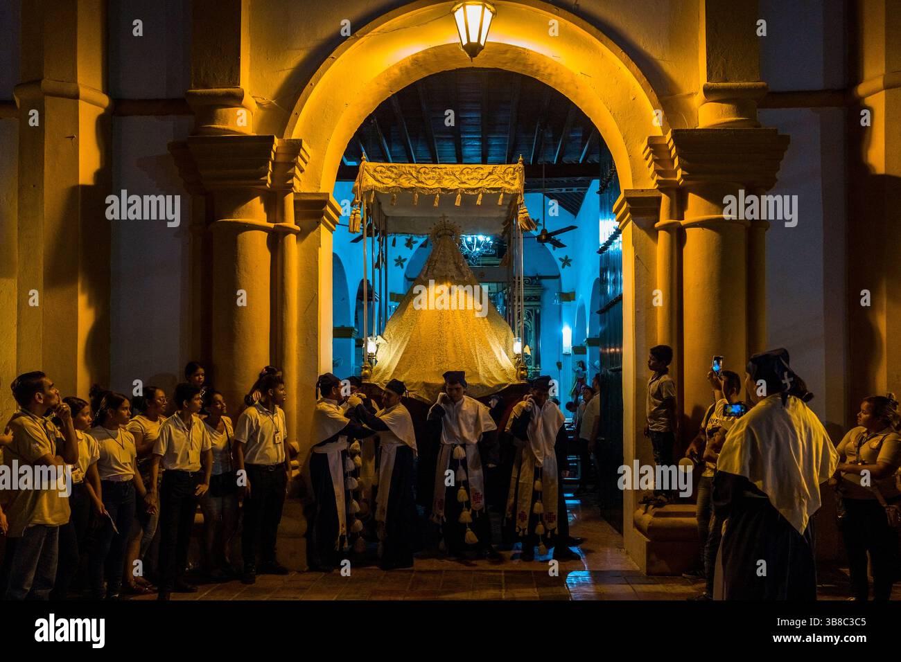 Nazarenos, devoti membri di una confraternita religiosa, portano un galleggiante (paso) durante la processione della settimana Santa a Mompox, Colombia. Foto Stock
