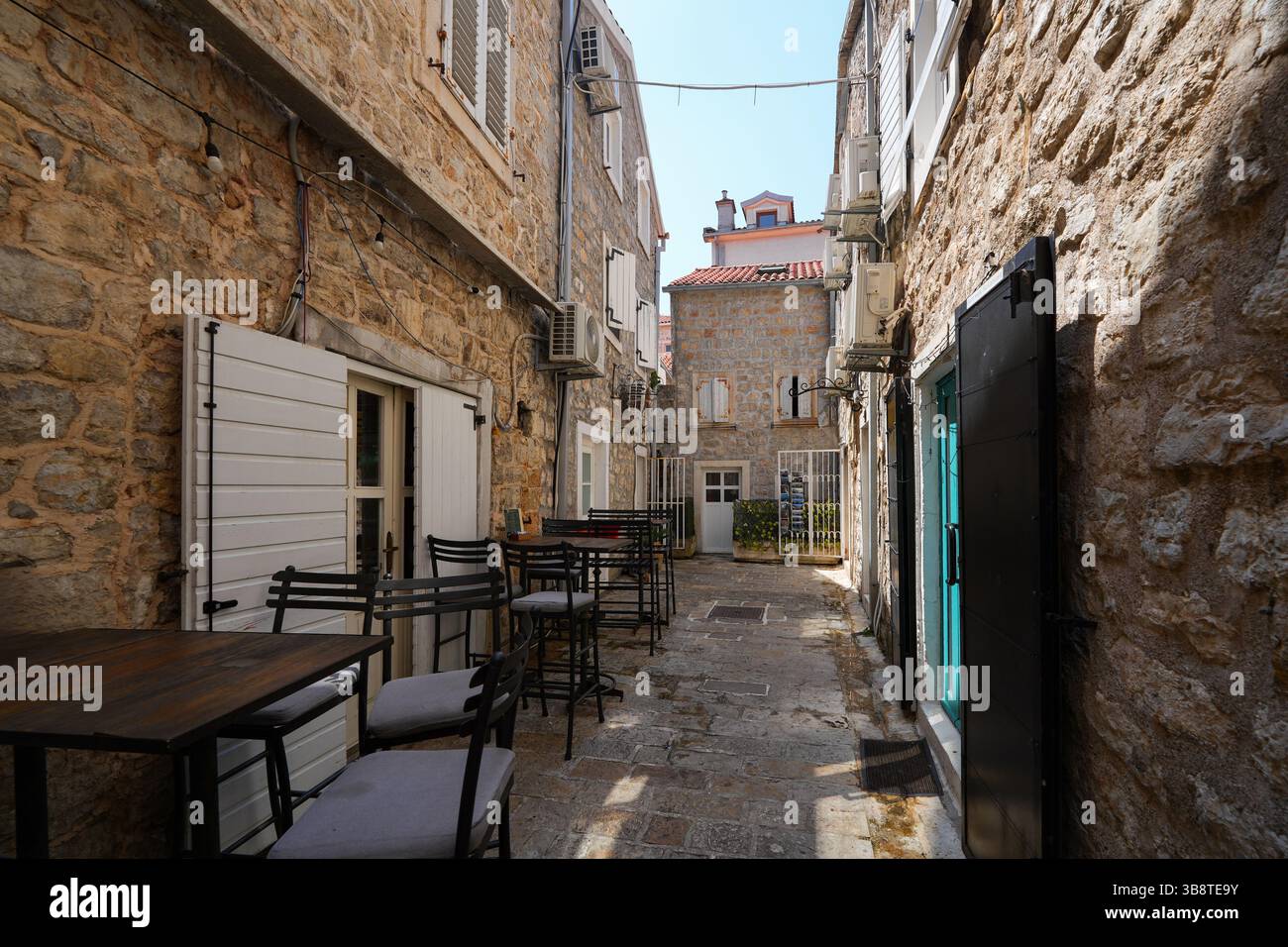 Stretta strada lastricata nella città vecchia di Budva, una città costiera fortificata costruita dalla Repubblica di Venezia lungo la costa del mare Adriatico in Montenegro Foto Stock