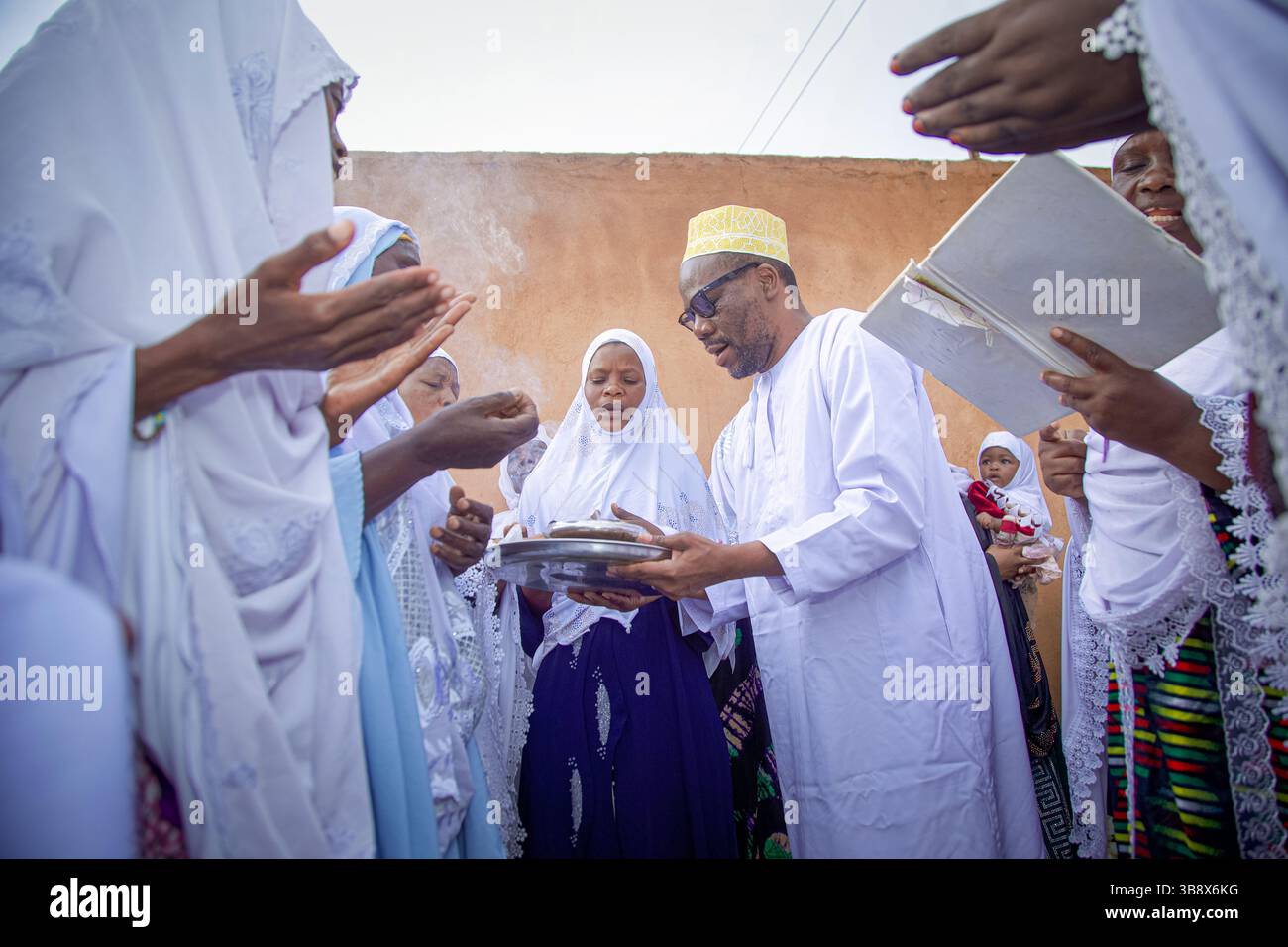 Donne musulmane che hanno completato l'Hajj pregando per l'ex leader del partito Wazalendo Zitto Kabwe nella sua casa nella città di Kigoma, Tanzania Foto Stock