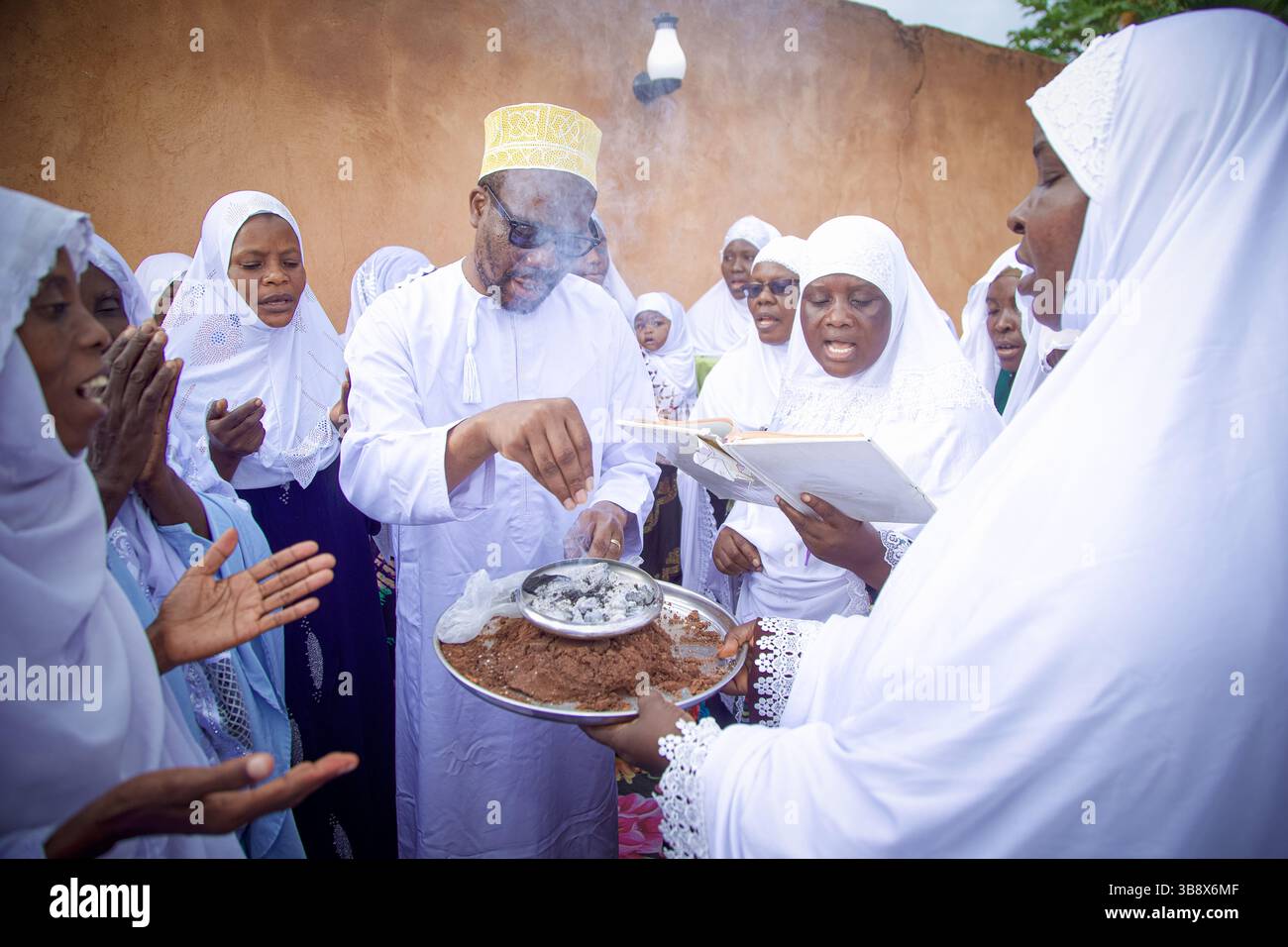 Donne musulmane che hanno completato l'Hajj pregando per l'ex leader del partito Wazalendo Zitto Kabwe nella sua casa nella città di Kigoma, Tanzania Foto Stock