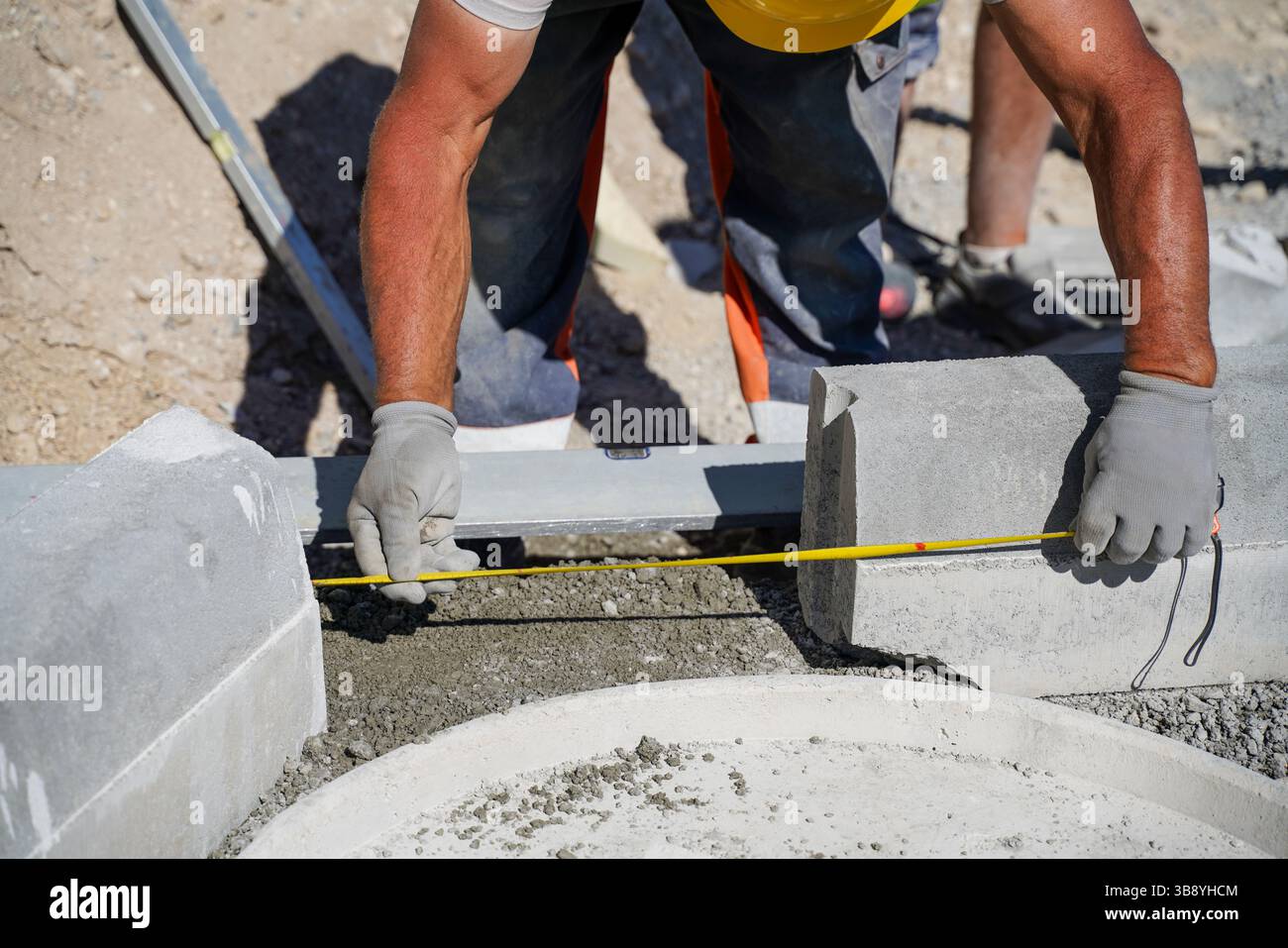 Distanza di misurazione tra due cordoli per un'installazione precisa nel cantiere di costruzione di autostrade Foto Stock
