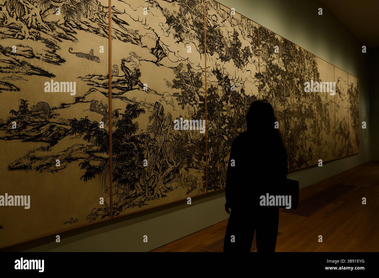 Visitatore che osserva gli intricati dettagli del Giardino dei semi di senape bianco e nero (racconto della serie dell'11° giorno) presso il Museo M+ Foto Stock