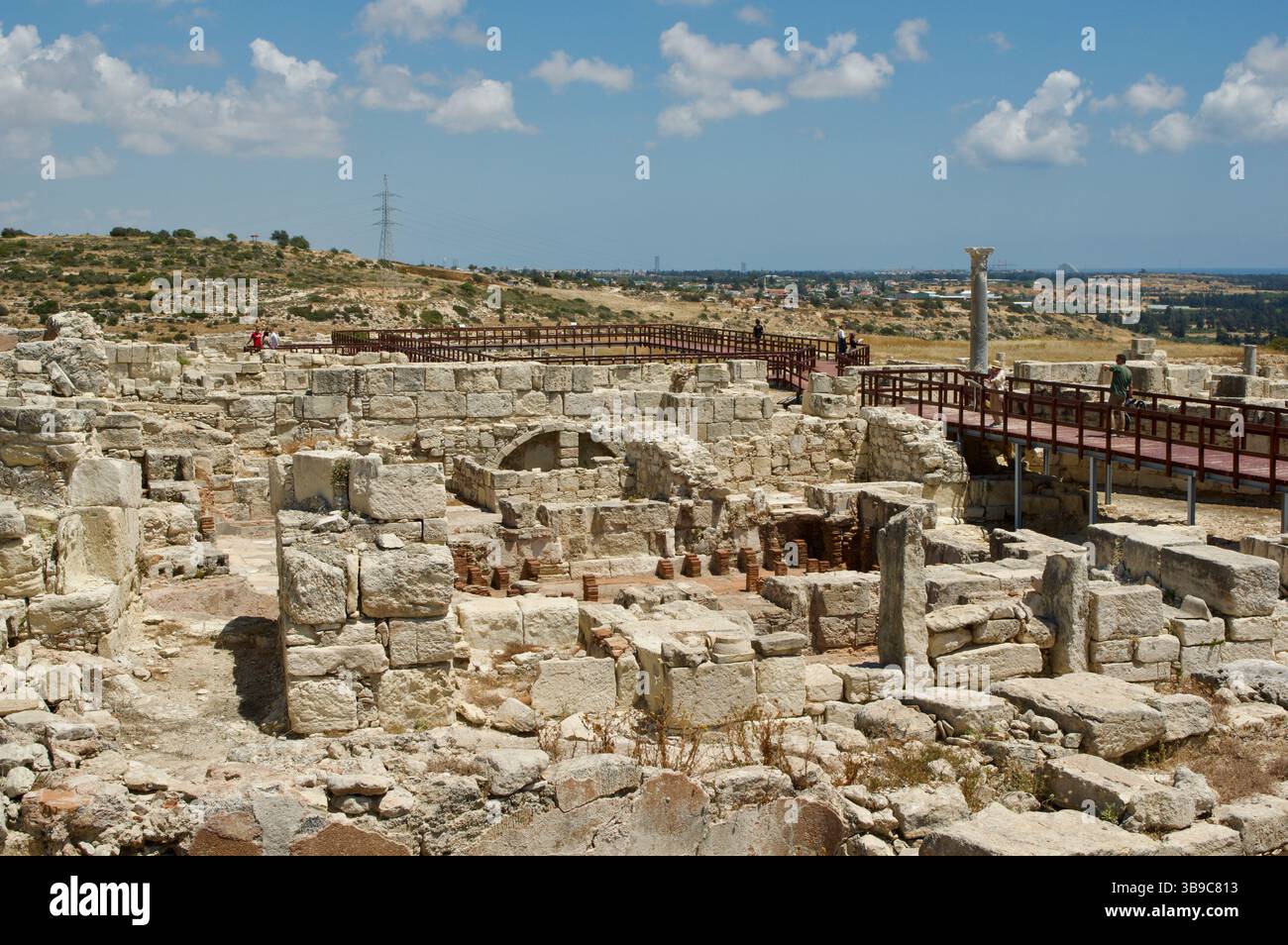 Antiche rovine con strutture in pietra adagiate su uno sfondo panoramico che mostra storia e architettura. Foto Stock