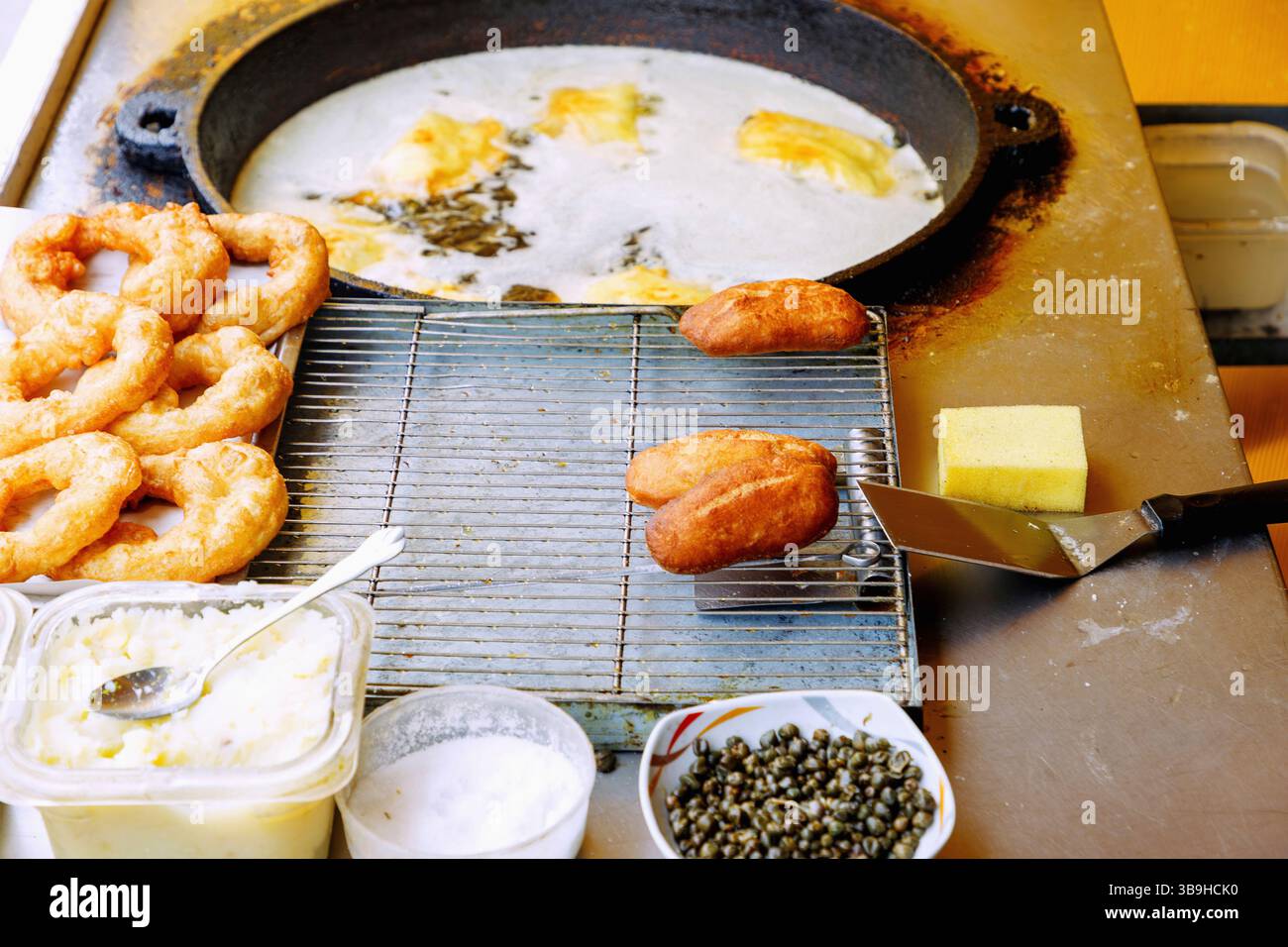 Friggere brik (gnocchi con purè di patate, capperi e uova) in grasso caldo in una bancarella di cibo ad Hammamet, Tunisia Foto Stock