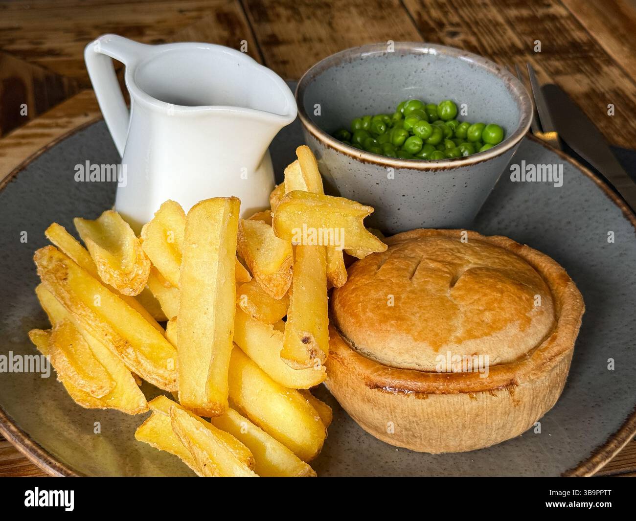Piatti tradizionali britannici da pub, tra cui torte chips piselli e sugo di carne da vicino Foto Stock