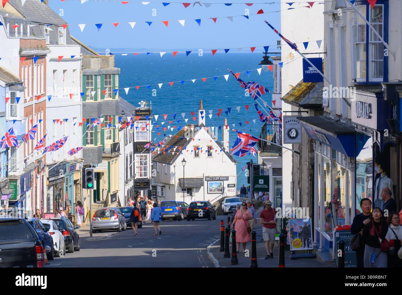 Lyme Regis, Dorset, Regno Unito. 10 maggio 2025. Meteo nel Regno Unito: Bunting e bandiere sono esposte con orgoglio su Broad Street in occasione del 80° anniversario del VE Day in una gloriosa giornata di sole. Crediti: Celia McMahon/Alamy Live News Foto Stock