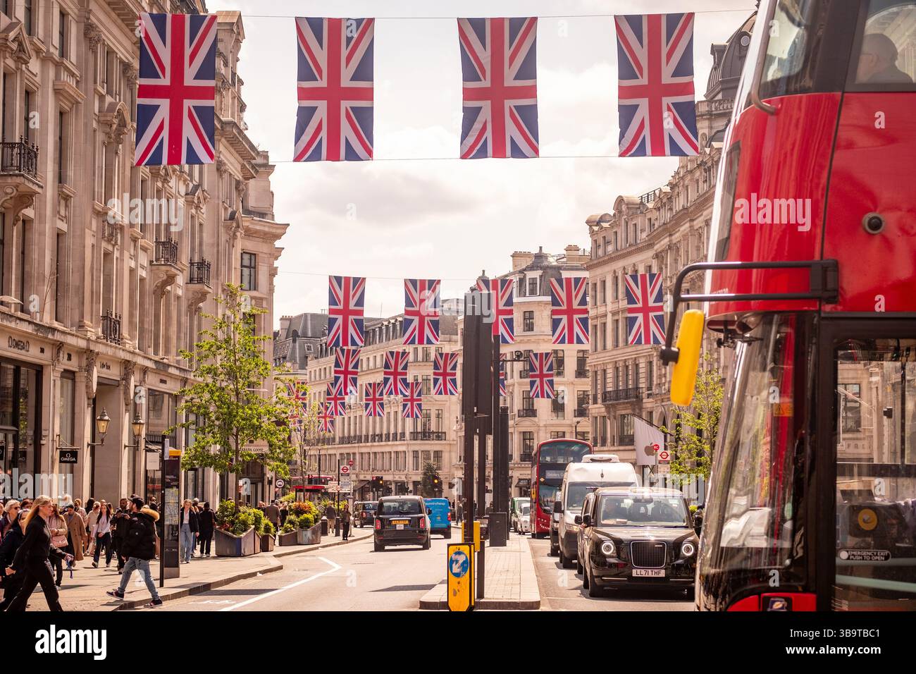 LONDRA - 8 MAGGIO 2025: Bandiere Union in mostra sopra Regent Street, una destinazione per lo shopping nel West End di Londra Foto Stock