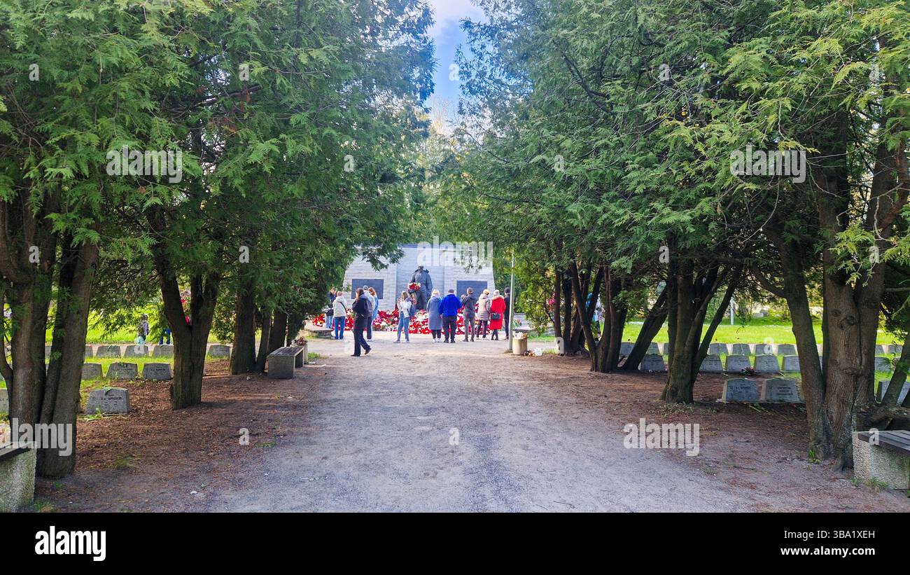 Controverso memoriale di guerra sovietico della seconda guerra mondiale a Tallinn. Il 9 maggio, molti russi etnici in Estonia, commemorano il giorno della Vittoria portando fiori rossi. - Immagine stock catturata con smartphone