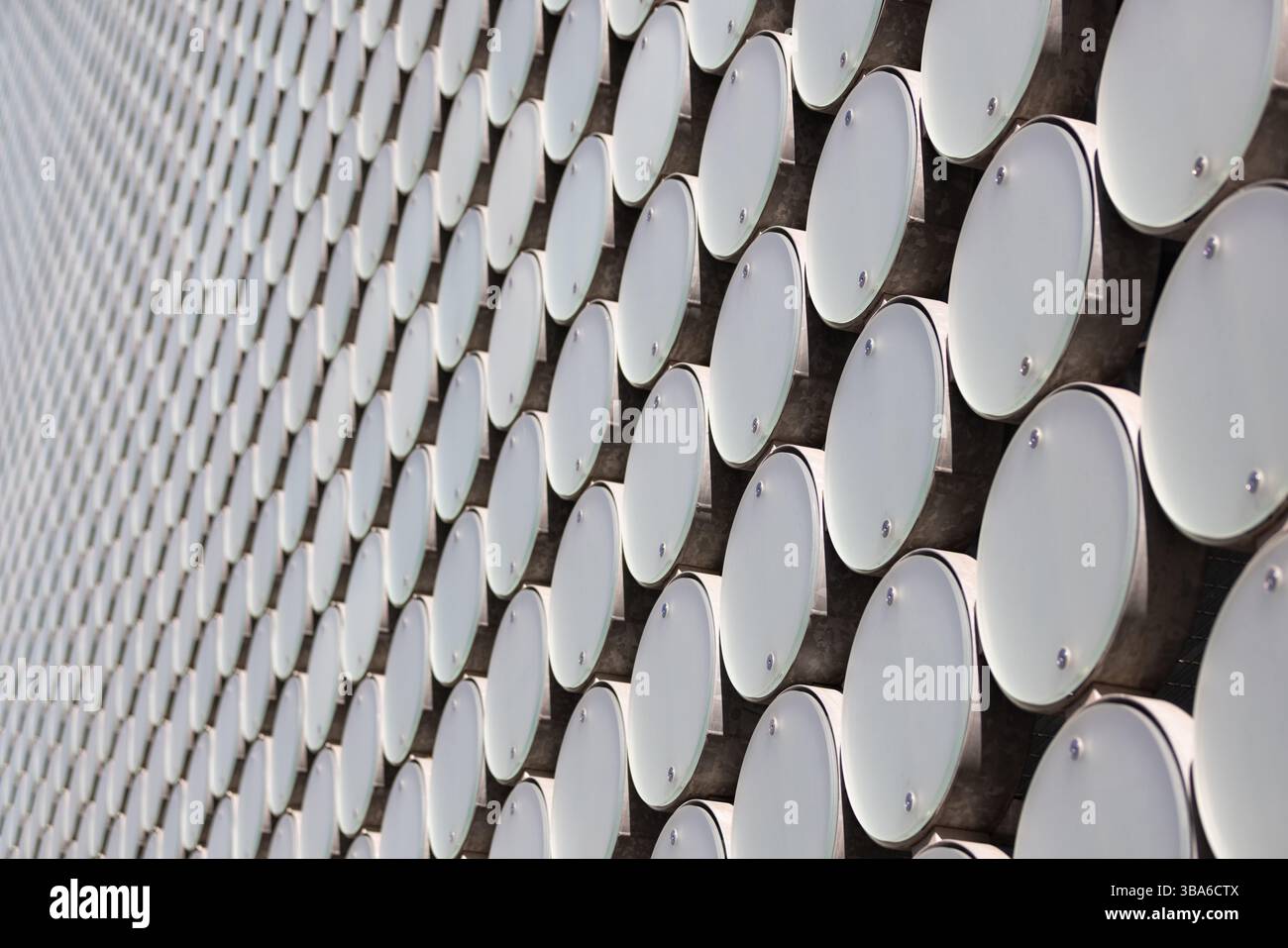 Cerchi ripetuti con motivi geometrici su un moderno edificio esterno Foto Stock