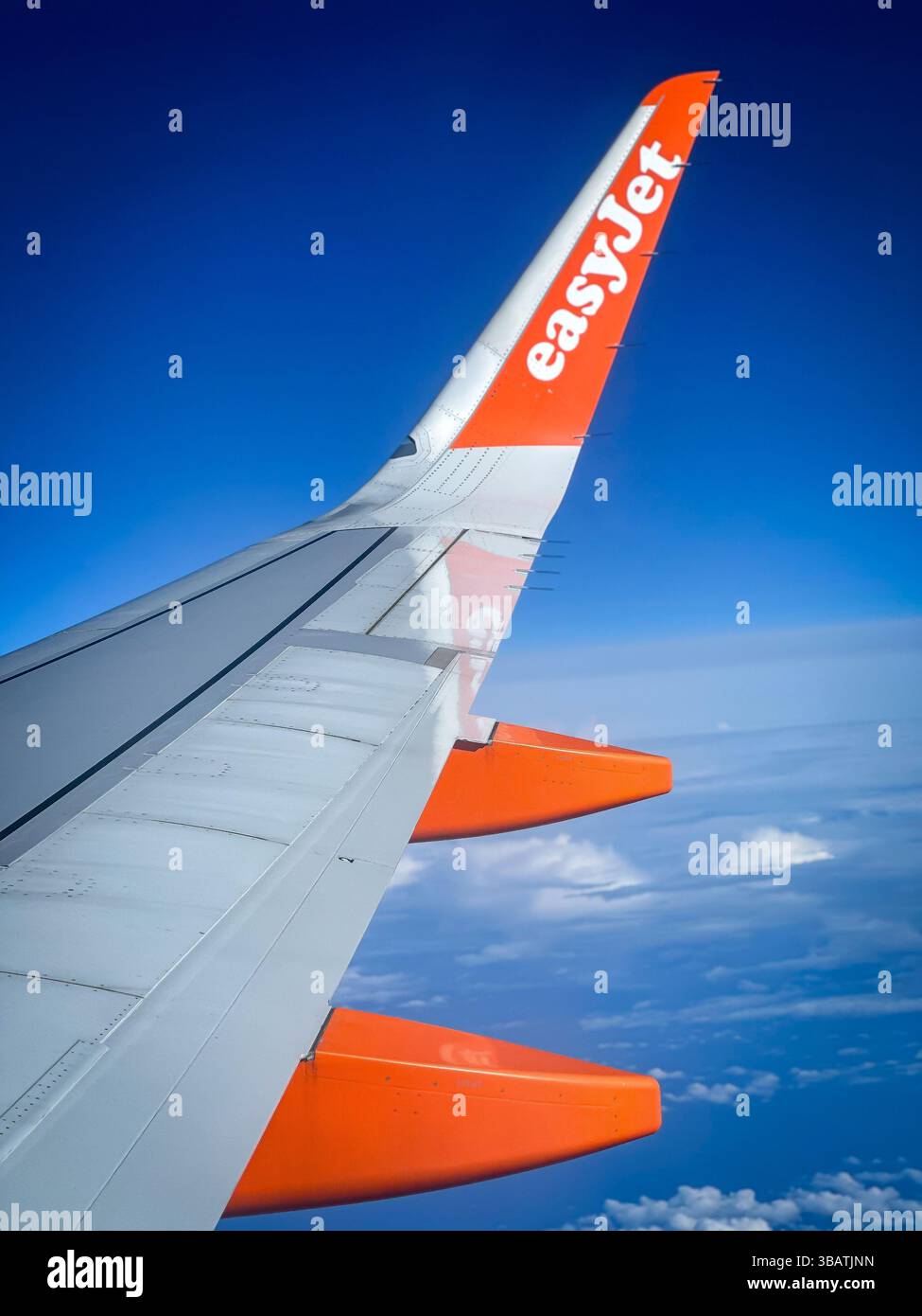 Sorvolando le nuvole a bordo di un Airbus A320 easyJet, questa splendida vista dell'ala cattura la bellezza del volo in una giornata limpida, con cieli blu profondi Foto Stock Sorvolando le nuvole a bordo di un Airbus A320 easyJet, questa splendida vista dell'ala cattura la bellezza del volo in una giornata limpida, con cieli blu profondi Foto Stock