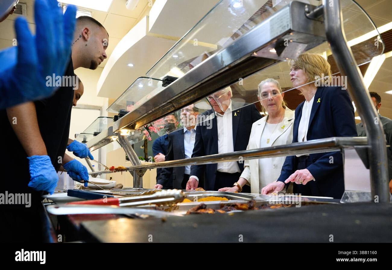 14 maggio 2025, Israele, Beeri (BE'eri): Il presidente federale Frank-Walter Steinmeier e sua moglie Elke Büdenbender, insieme a Izchak Herzog, presidente di Israele, e sua moglie Michal Herzog, visitano Kibbutz Beeri nella zona di confine con la Striscia di Gaza nel sud di Israele e mangiano nella mensa locale. Kibbutz Beeri (Be'eri) è uno dei luoghi più duramente colpiti dai massacri terroristici di Hamas nel 2023. Quasi il 20% dei suoi oltre 1.000 abitanti sono stati uccisi o deportati nella Striscia di Gaza. Per segnare l'instaurazione di relazioni diplomatiche tra la Repubblica federale di Germania e Israele 6 Foto Stock