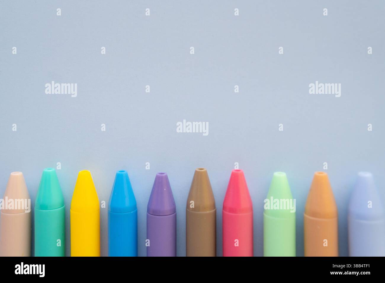 Composizione creativa di ritorno a scuola con biglietto giallo per l'autobus penne colorate e tazza su sfondo giallo brillante concetto di educazione minimale Foto Stock