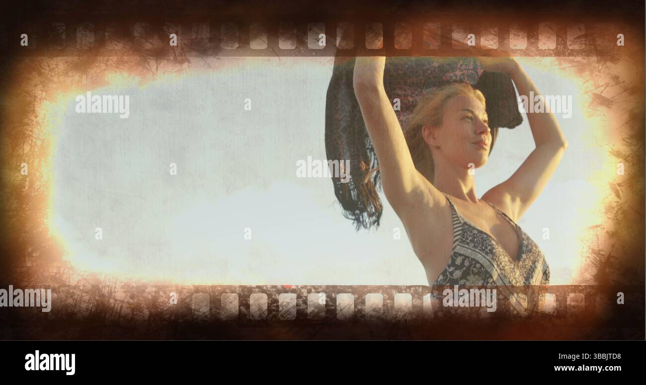 Tenendo lo scialle sopra la testa, la donna indossa un abito estivo a motivi geometrici che paillettes sulla costa, spazio per copiare Foto Stock