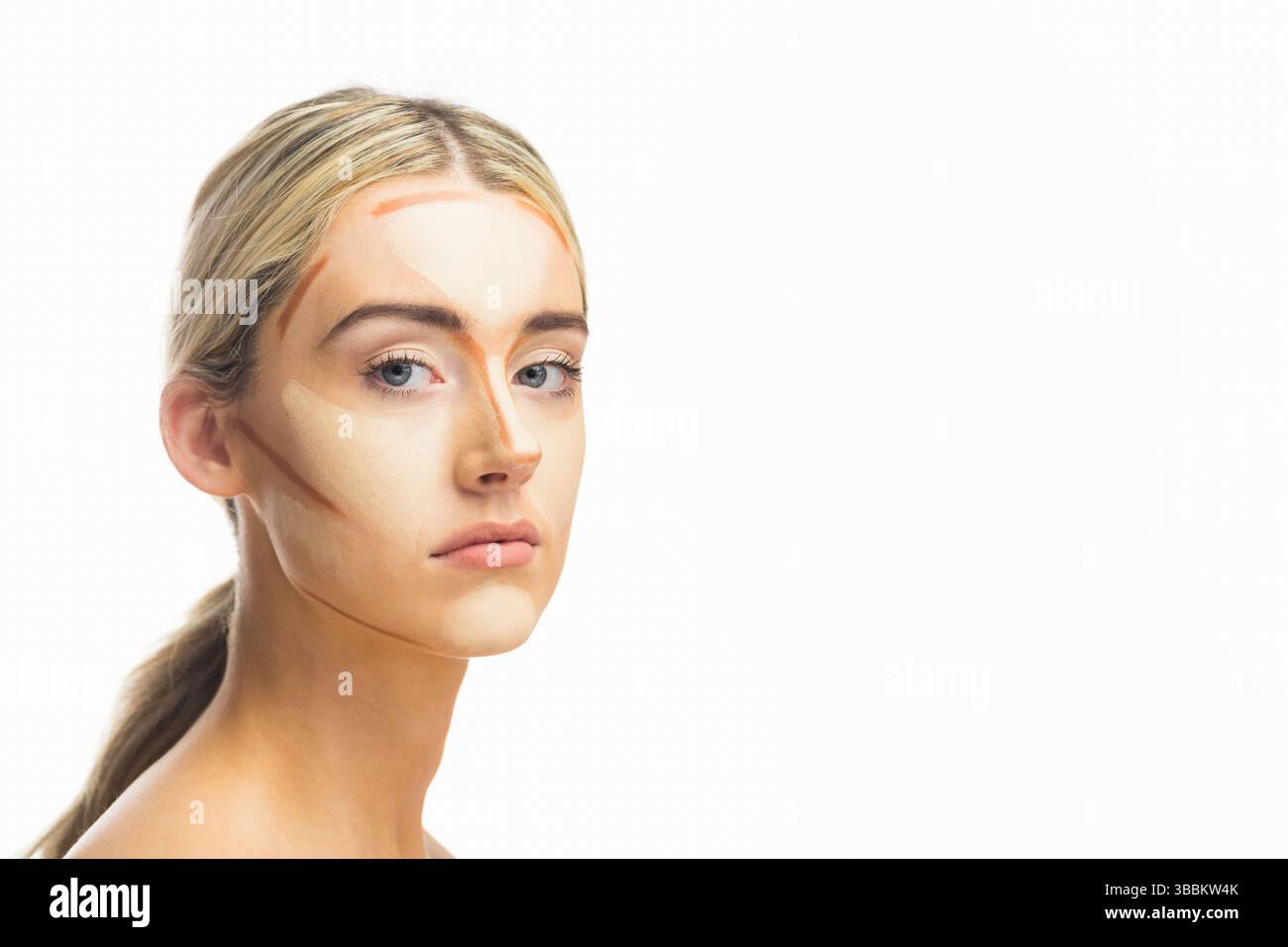 Donna in posa che indossa strisce color crema contorno in studio professionale, con sfondo bianco Foto Stock