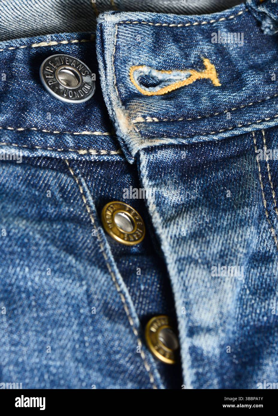 I jeans Pepe volano con bottoni in metallo sui jeans denim, chiusura ravvicinata di chiusure con marchio e texture in tessuto Foto Stock