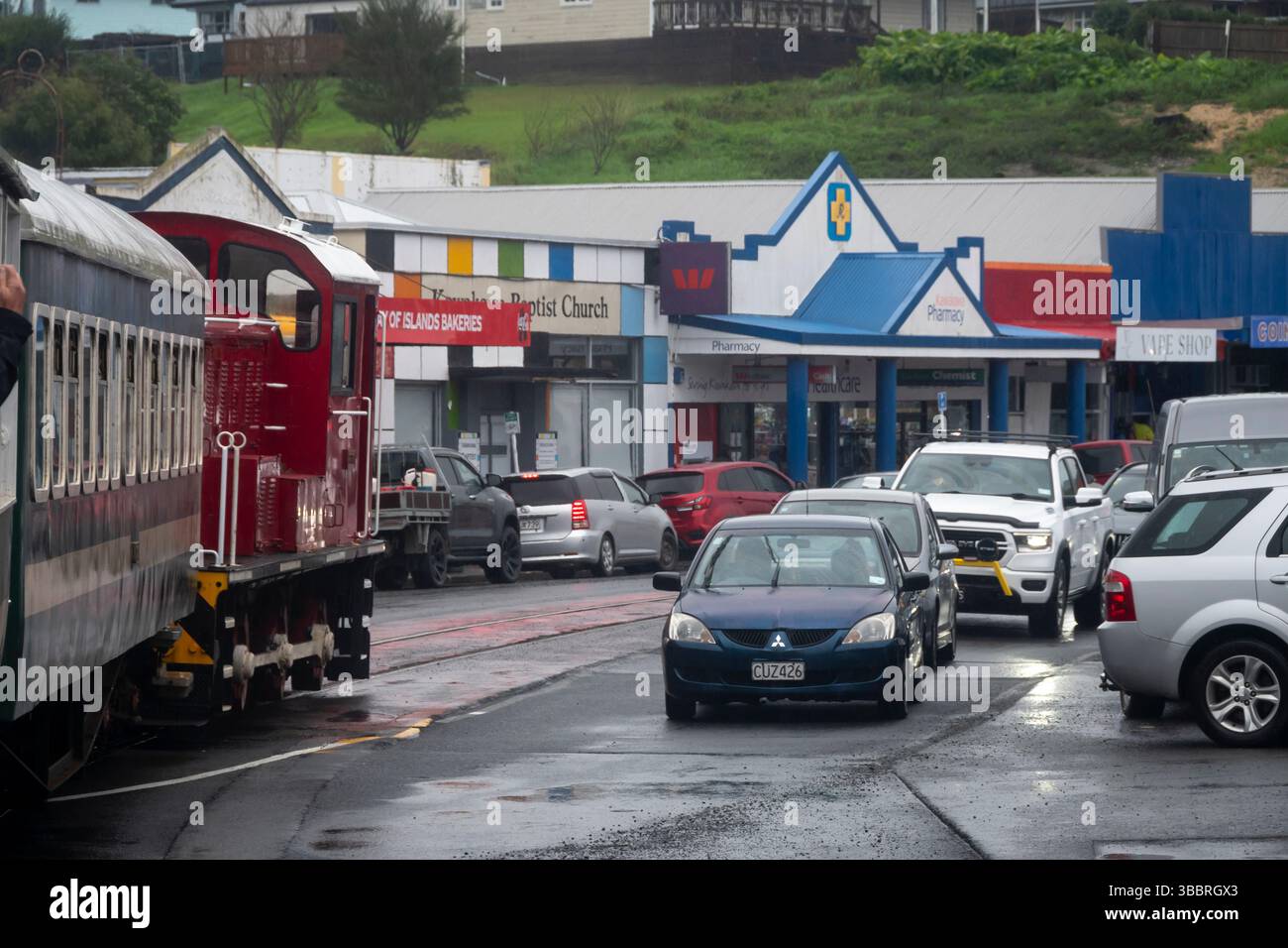 Il treno della Bay of Islands Vintage Railway attraversa la strada principale di Kawakawa, Bay of Islands, North Island, nuova Zelanda Foto Stock