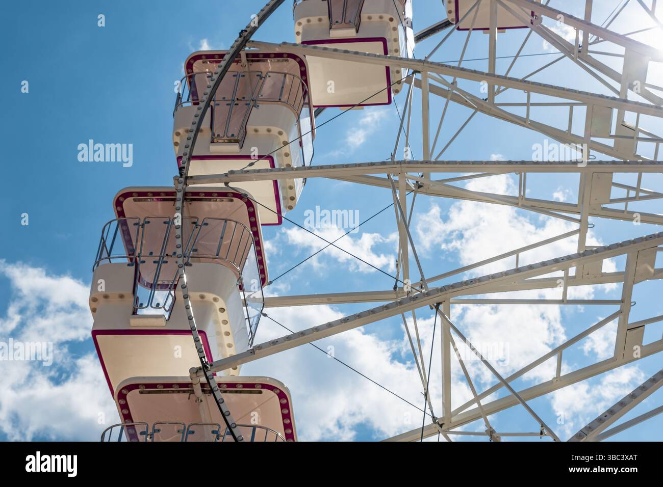 Cabine con ruota panoramica contro un cielo blu in un parco divertimenti cittadino. Foto ravvicinata di una ruota di un traghetto sotto un cielo azzurro. Foto di viaggio, nessuno Foto Stock