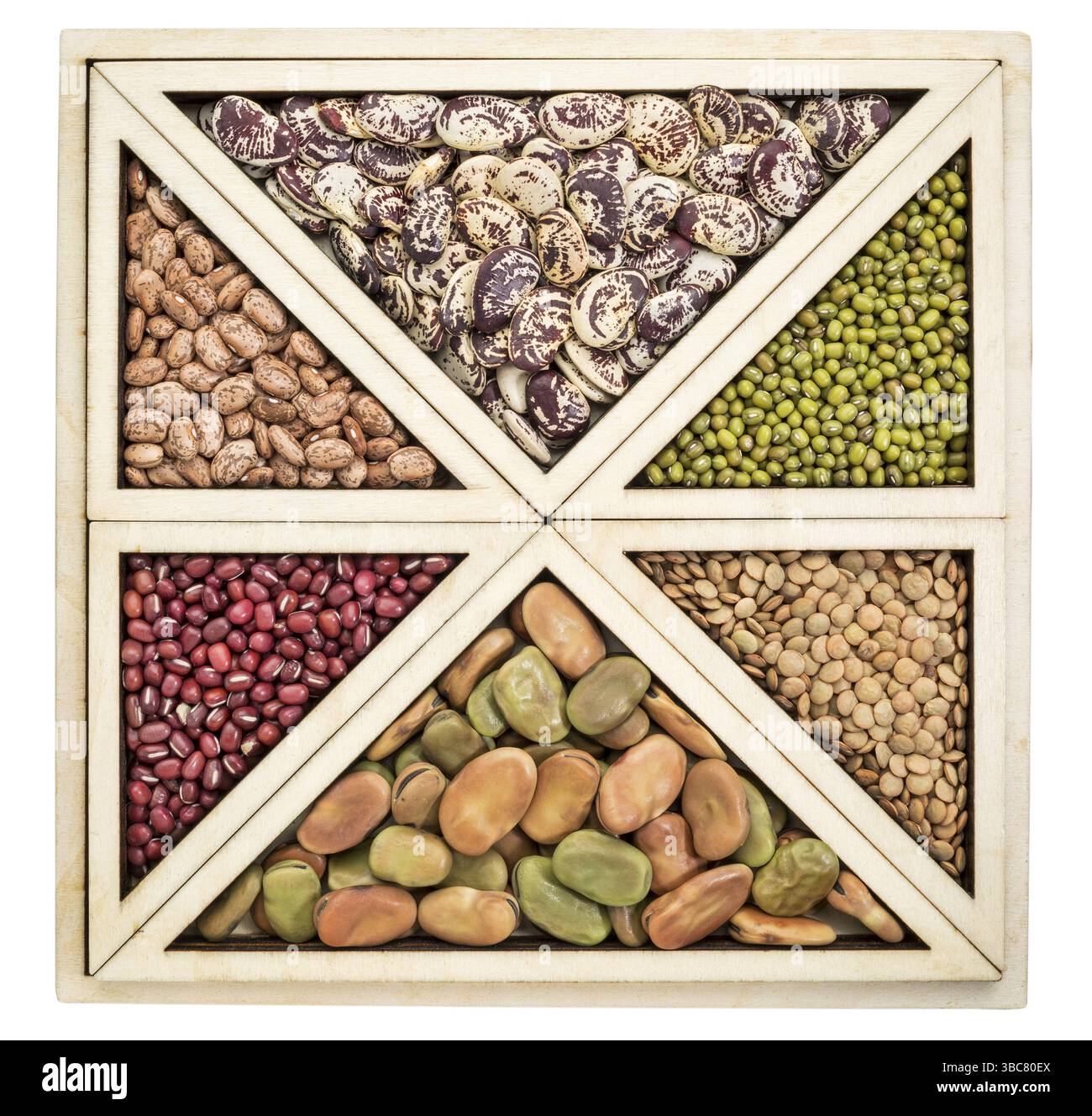 Triangoli e quadrati astratti - una varietà di fagioli e lenticchie in un vassoio di legno isolato Foto Stock