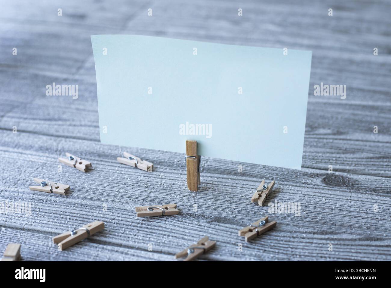 Nota quadrata vuota circondata da clip di lavanderia che mostrano una nuova idea Foto Stock