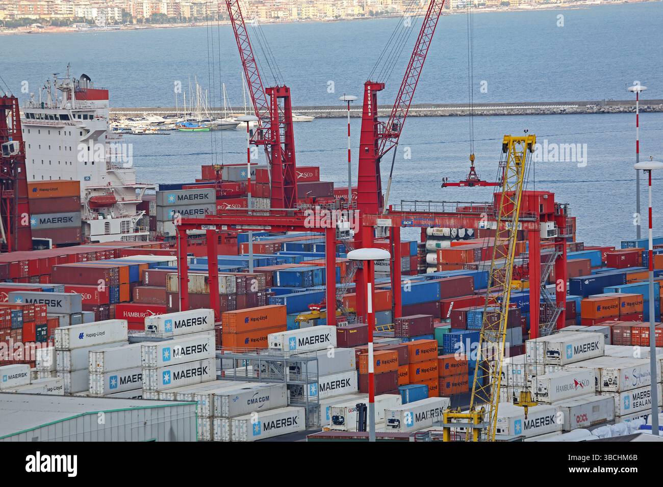 Salerno, Italia - 27 giugno 2014: Gru rosse Gottwald caricamento container intermodali al porto del terminal delle navi di carico. Foto Stock
