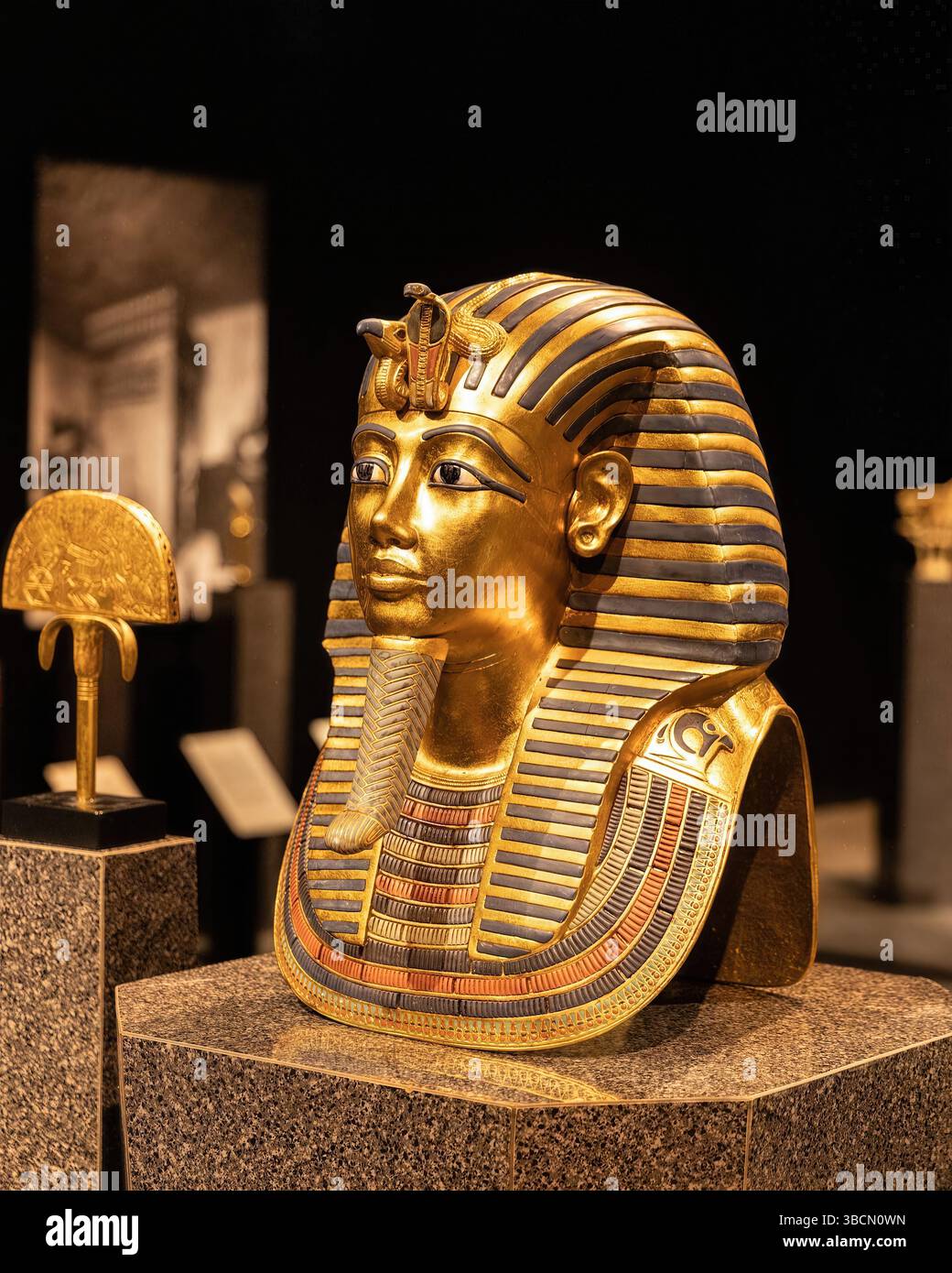San Francisco, California, Stati Uniti – 10 febbraio 2023: Una scintillante maschera dorata di un faraone poggia su un piedistallo di granito, evocando la riverenza reale Foto Stock