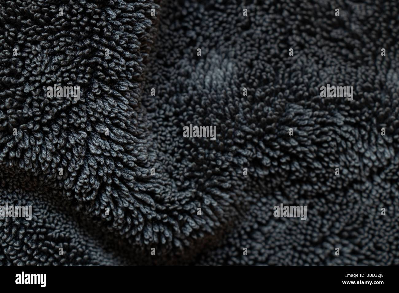 Sfondo in tessuto di spugna nero con trama ad anello, modello in tessuto morbido per design e presentazioni Foto Stock