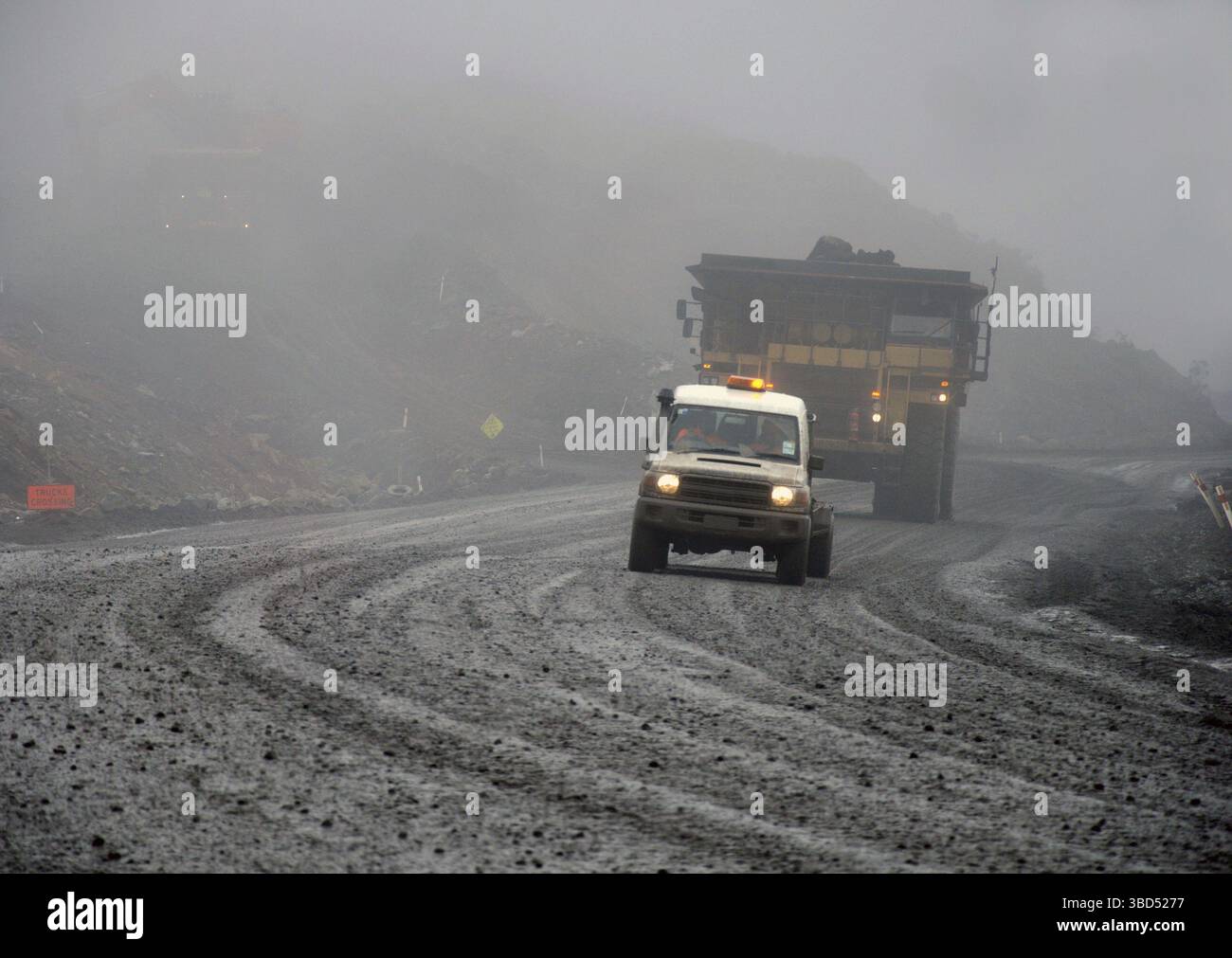 Veicoli che lavorano nella nebbia pesante in una miniera di carbone a cielo aperto, Westland, nuova Zelanda Foto Stock