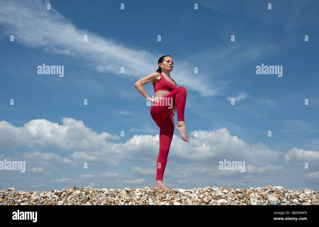 donna attiva che fa un esercizio di stretching delle gambe all'aperto Foto Stock