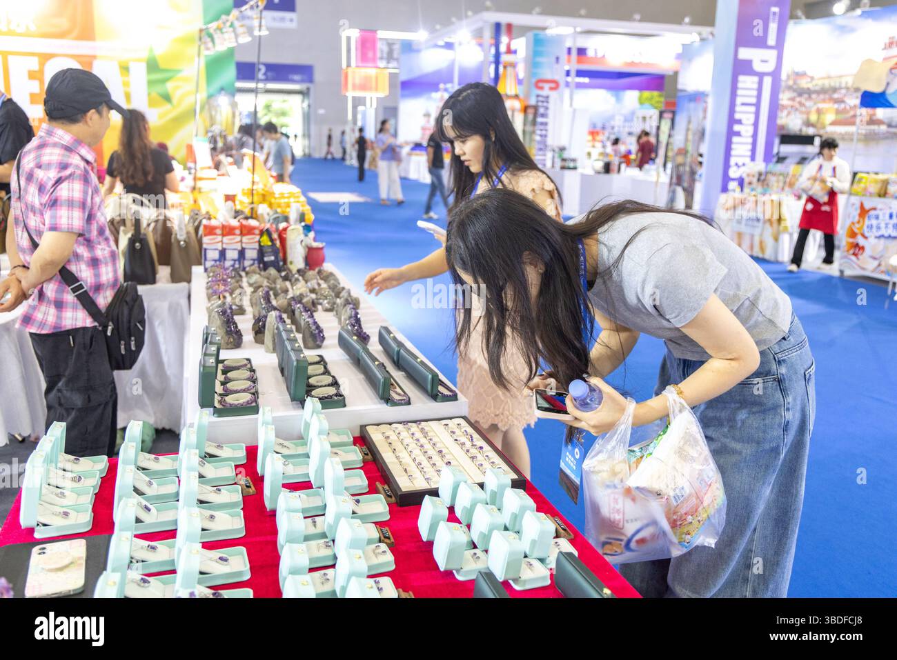 (250524) -- CHONGQING, 24 maggio 2025 (Xinhua) -- i visitatori osservano i prodotti gemellati presso il padiglione nazionale dell'Uruguay durante la settima fiera internazionale per gli investimenti e il commercio della Cina occidentale nella municipalità di Chongqing, 23 maggio 2025. Alla 7a Fiera internazionale per gli investimenti e il commercio della Cina occidentale a Chongqing, nel sud-ovest della Cina, il padiglione nazionale dell'Uruguay è diventato una calamita per la folla con la sua incredibile esposizione di pietre preziose di ametista viola, attirando curiosi curiosi desiderosi di saperne di più.PER ANDARE CON "Economic Watch: I prodotti uruguaiani guadagnano terreno nella Cina occidentale via terra- Foto Stock