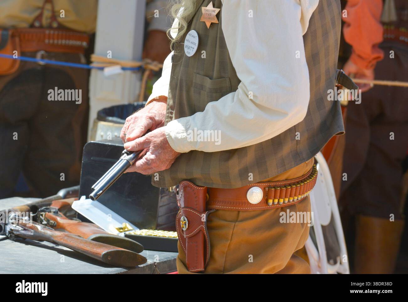 Cowboy Reenactor ricaricando il suo colt 45 per le strade di Tombstone, Arizona Foto Stock