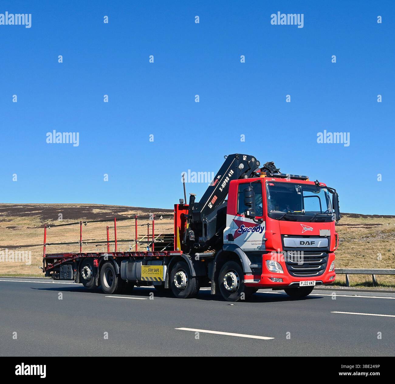 Speedy Hire HGV con gru a carico HIAB X-HIPRO 418, viaggiando a velocità sostenuta sulla superstrada M6 direzione sud, Shap, Cumbria, Inghilterra, United King Foto Stock
