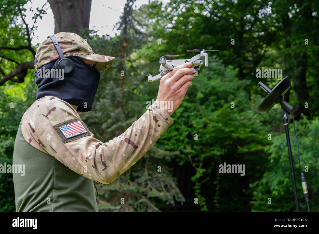 Un operatore militare usa un drone e comunicazioni satellitari per una missione tattica Foto Stock