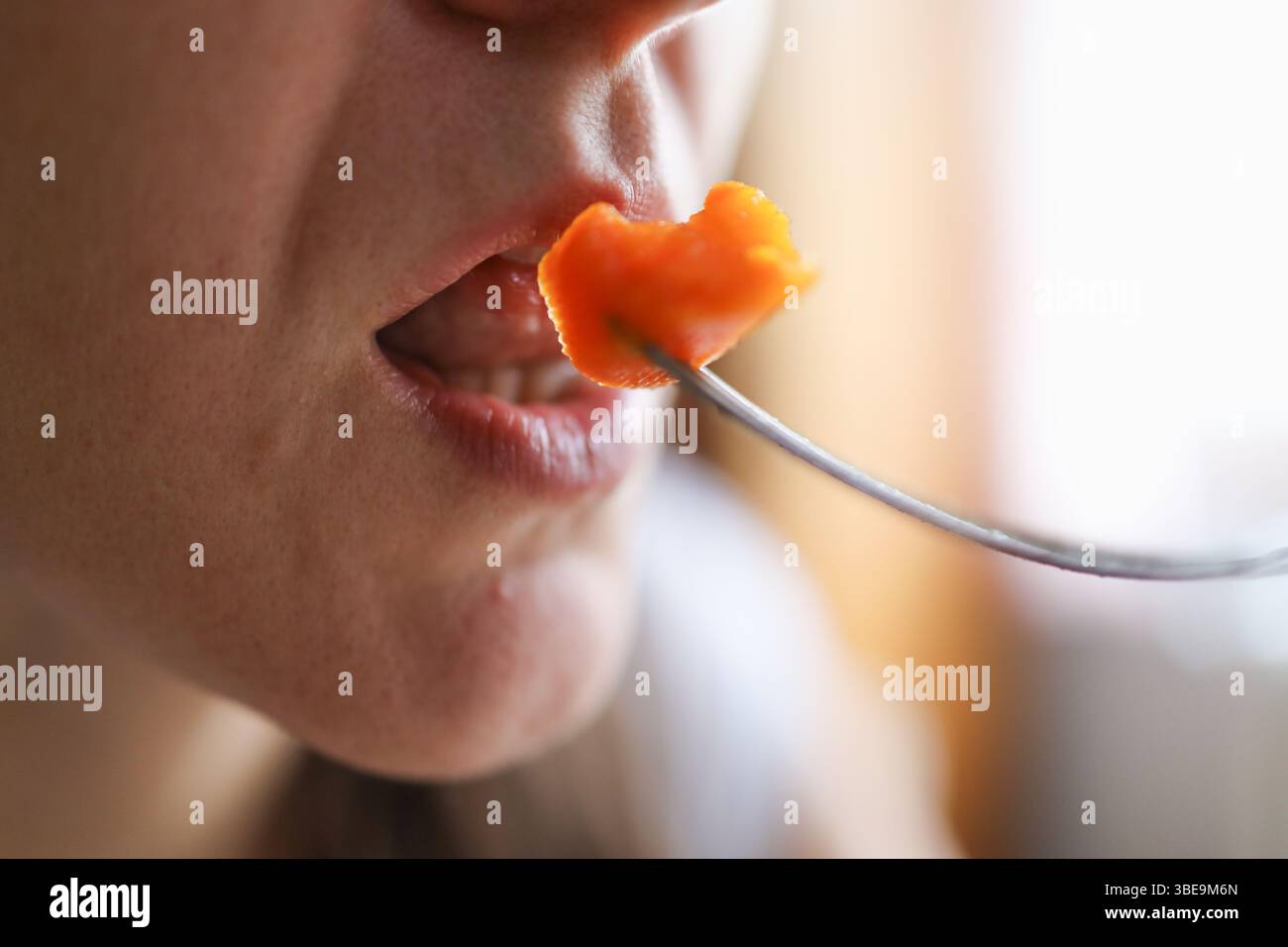 Morso nutriente: Donna che mangia carota come spuntino nutriente ricco di vitamina. Foto Stock