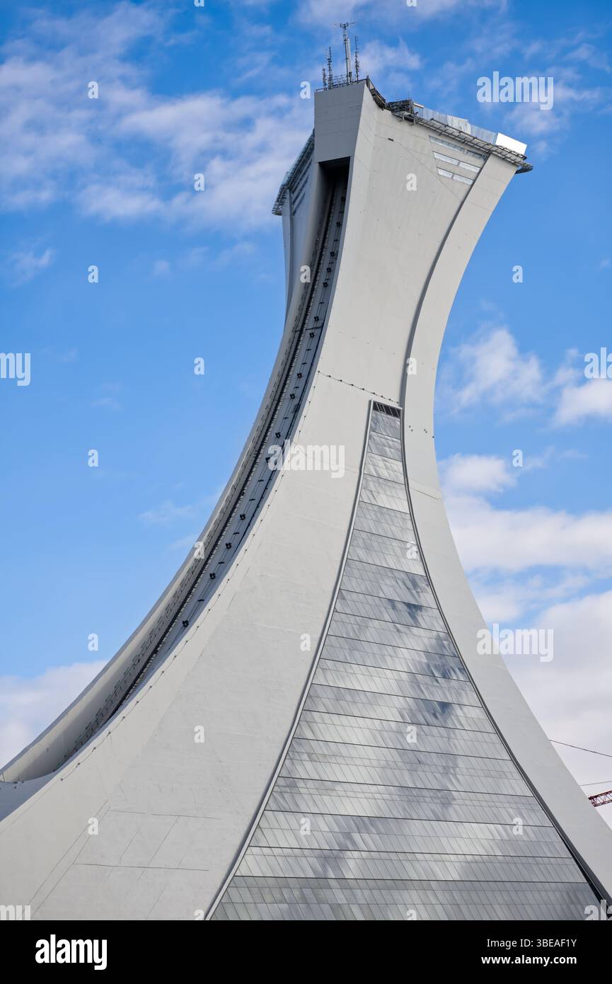 La Torre di Montreal, la struttura inclinata più alta di 165 m, si erge dallo Stadio Olimpico contro un cielo blu con morbide nuvole sullo sfondo. Foto Stock