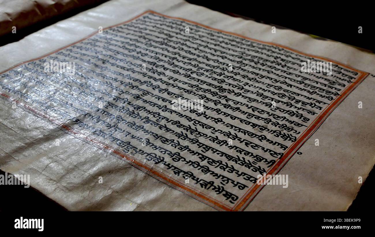 Questo manoscritto scritto Guru Granth Sahib, conosciuto come "Sunehri bir", è ospitato a Gurdwara Mattan Sahib a Martand, Kashmir, India. Si ritiene che risalga al XVII secolo, presenta la sacra scrittura del sikhismo. Il manoscritto è stato creato da uno scriba e un artista sconosciuti. Le fotografie di questo manufatto sono state scattate da Harkiran Kaur. Foto Stock