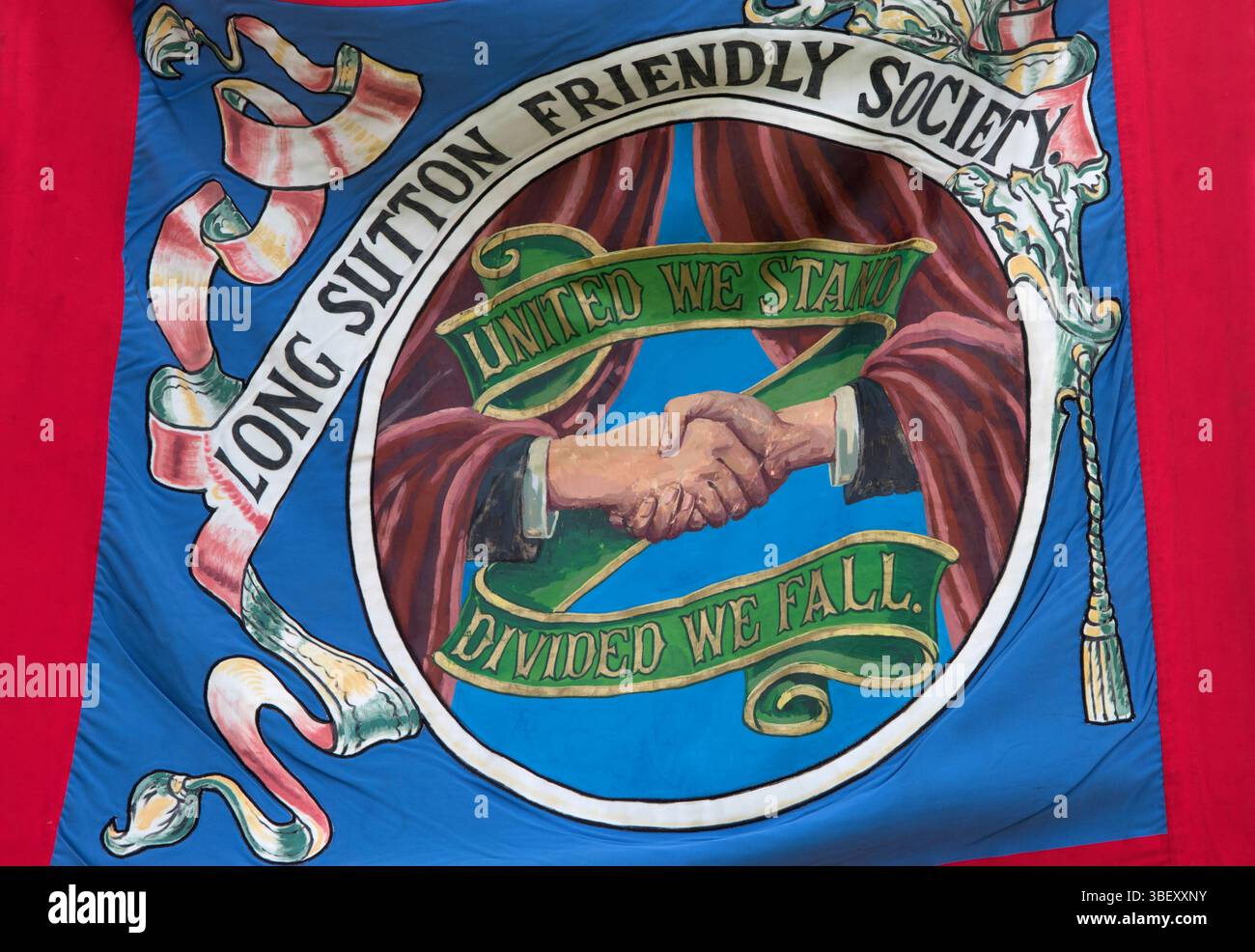 Long Sutton Friendly Society Club Banner. United We Stand Divided We Fall, un paio di mani strette. allungare e stringere le mani. Long Sutton, Somerset, Inghilterra 2019 UK 2010s HOMER SYKES Foto Stock