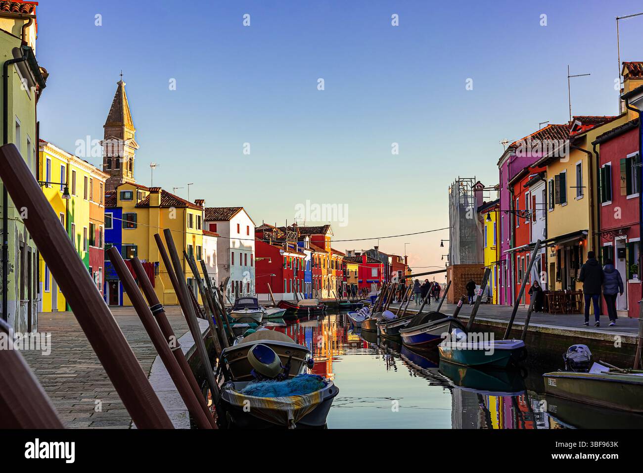 Gli affascinanti canali di Burano con le barche ormeggiate al molo Foto Stock