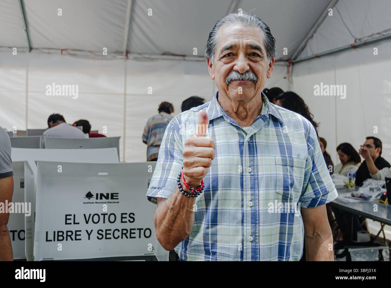 I cittadini alzano con orgoglio il pollice per indicare la loro partecipazione alle prime elezioni giudiziarie del paese. Foto Stock