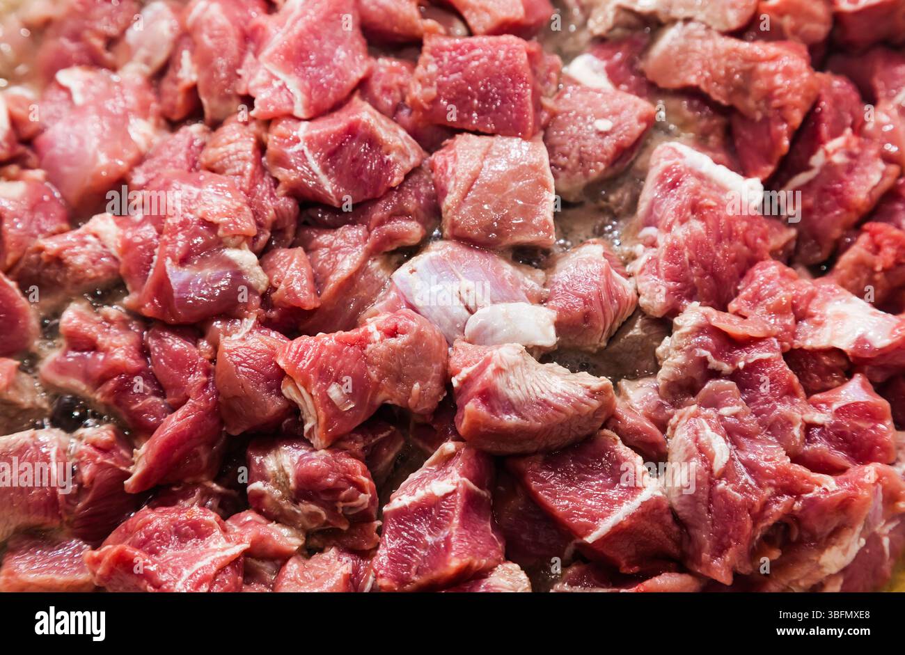 Pezzi a dadini di arrosto di manzo crudo, primo piano. Foto Stock