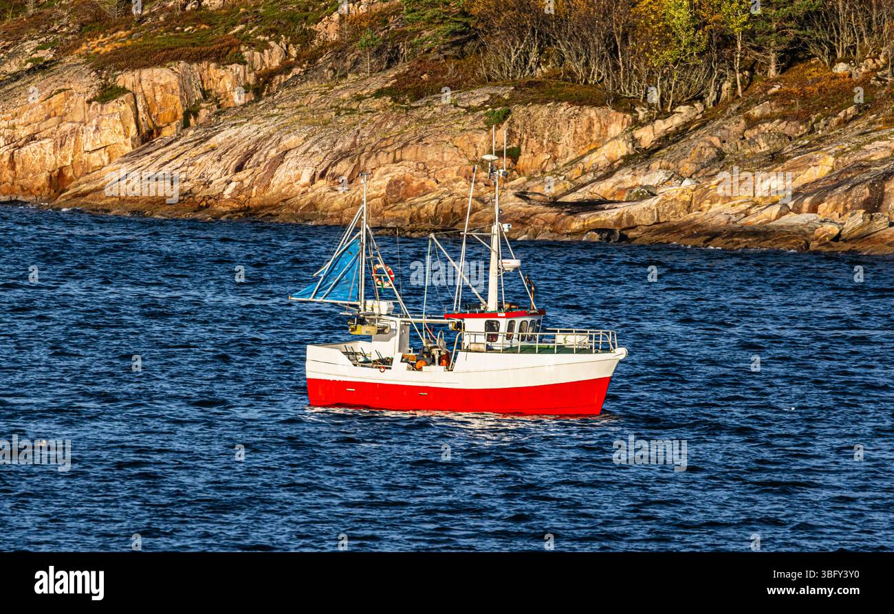 Ein kleines Fischerboot ist in den Morgenstunden unterwegs auf dem norwegischen Meer(Küstengebiet Norwegen, Region Nordland, 13.10.2023) Foto Stock