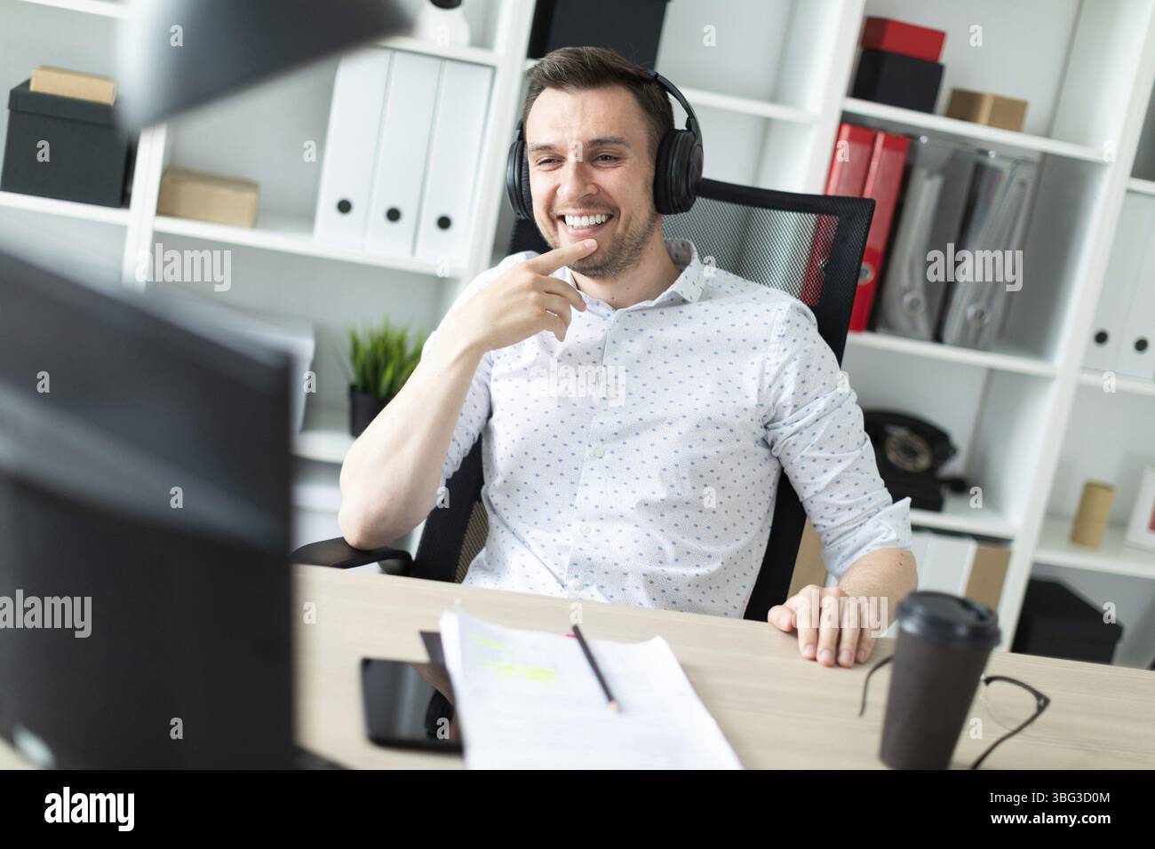 Un giovane uomo in pantaloni blu e una maglietta di luce. Un bel giovane con una stoppia sul suo viso. foto con profondità di campo Foto Stock
