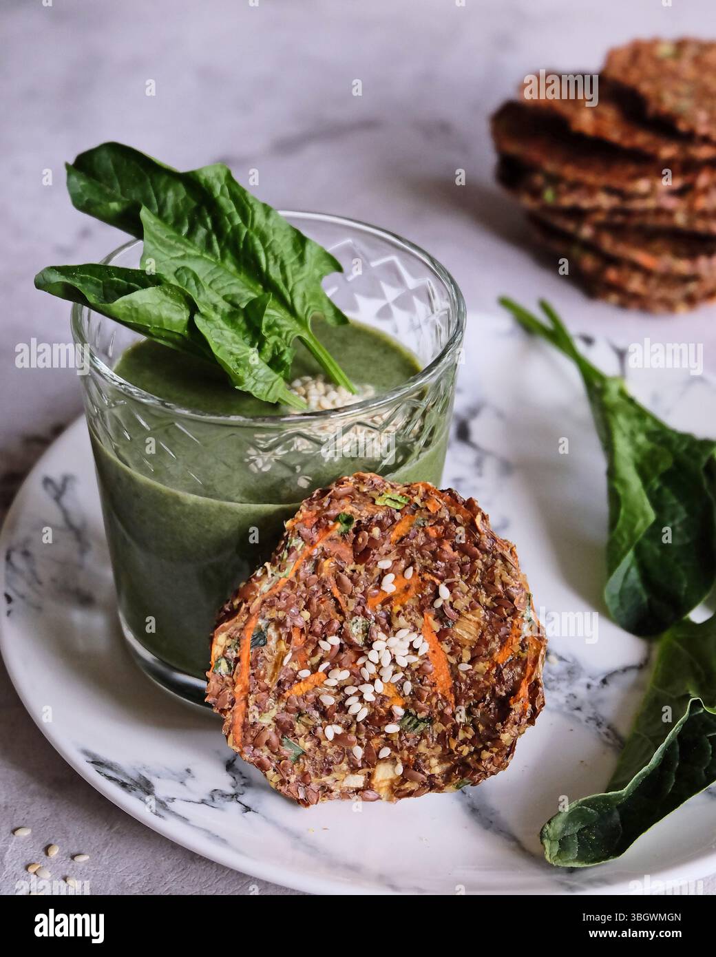Un frullato verde delizioso e salutare abbinato a snack croccanti per un benessere completo Foto Stock