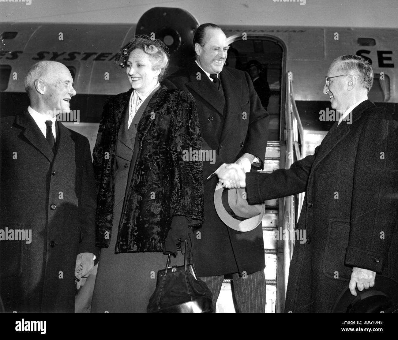 Il principe ereditario Olav di Norvegia (il secondo da destra) stringe la mano all'ambasciatore norvegese negli Stati Uniti Wilhelm Munthe De Morgenstierne (a destra) mentre arriva con sua moglie la principessa ereditaria Martha (la seconda da sinistra) all'aeroporto di Idlewild. Parlando con la Principessa c'è l'ambasciatore Arne Sunde, delegato norvegese alle Nazioni Unite. 19 gennaio 1950 Foto Stock