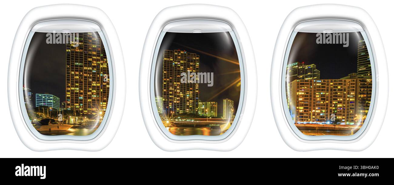 Tre finestre piane sul porto di Ala Wai, lo skyline di Honolulu di notte, Oahu, Hawaii, da un aereo sulle finestre dell'oblò. Copia spazio Foto Stock