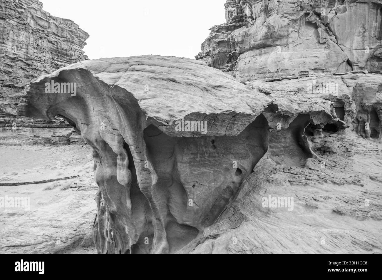 Una grande formazione rocciosa con un foro al centro. La roccia è grigia e ha un bordo frastagliato. L'immagine ha una sensazione di umorismo e mistero Foto Stock