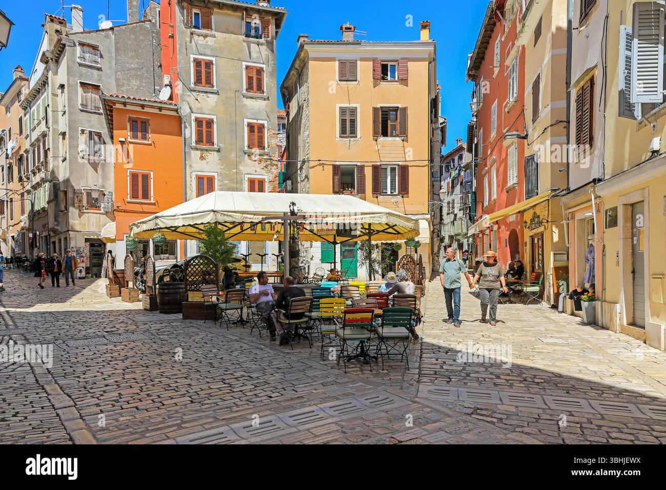 Caffetterie e ristoranti, edifici alti e vicoli stretti a Piazza Matteotti, Rovigno, Istria, Croazia, Europa Foto Stock