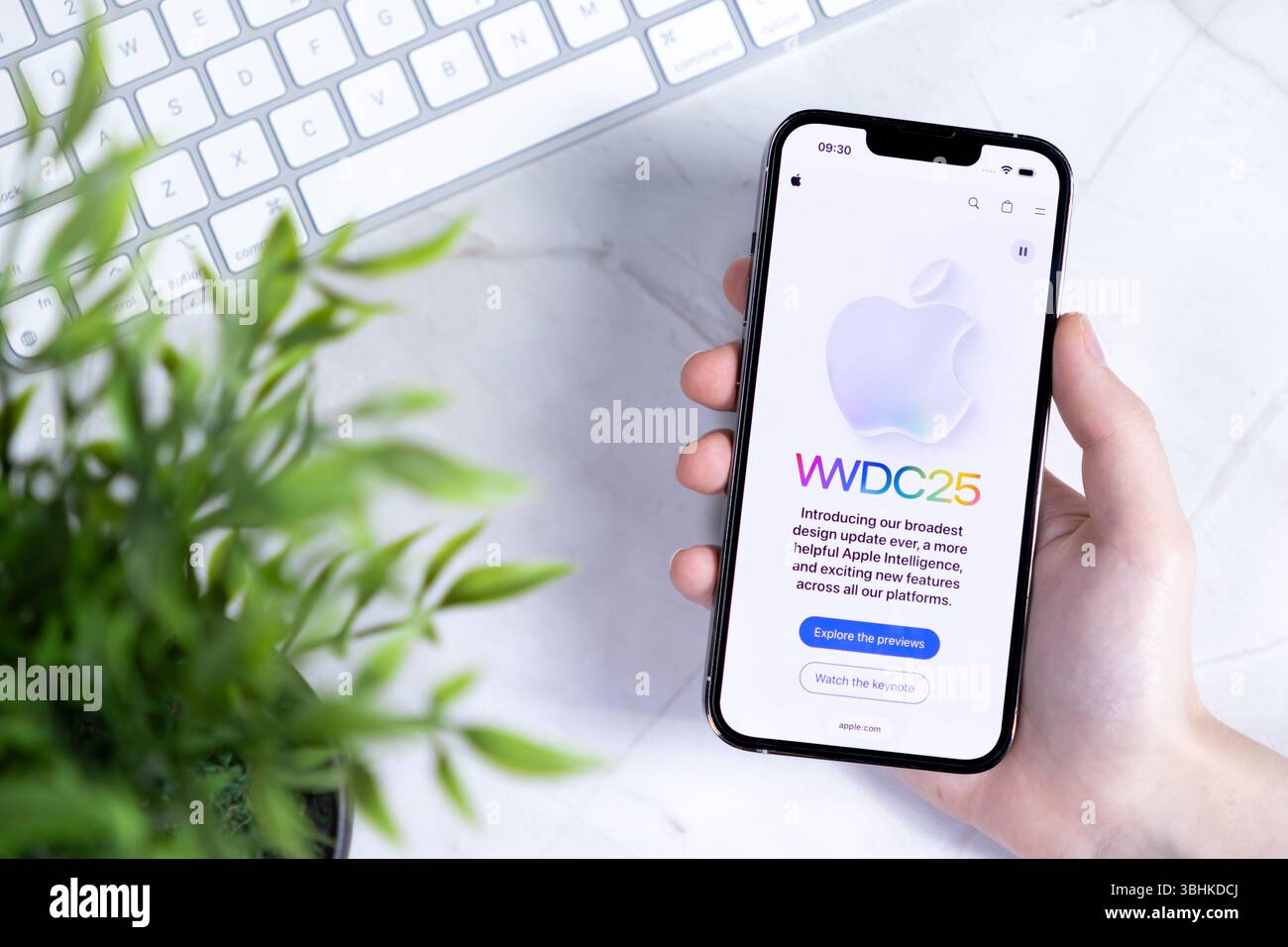 Poznan, Polonia - 10 giugno 2025: Primo piano di una mano che regge un iPhone Apple che mostra il sito Web WWDC25 con il nuovo iOS 26 e Liquid Glass nel design Foto Stock