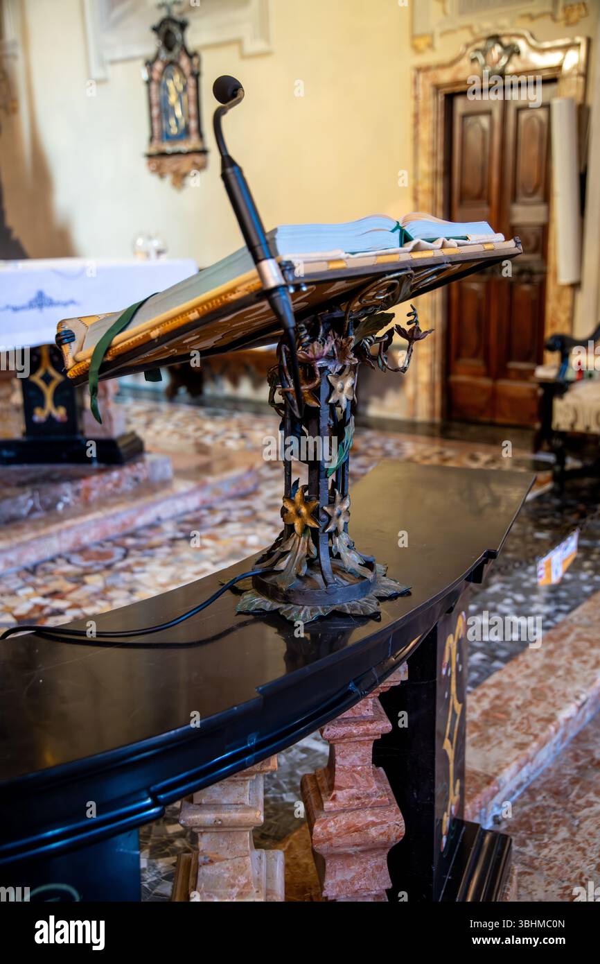 Brunate, Lombardei - Italia - 06-28-2024: Un pulpito dal design complesso con microfono, utilizzato per le letture in chiesa. Foto Stock