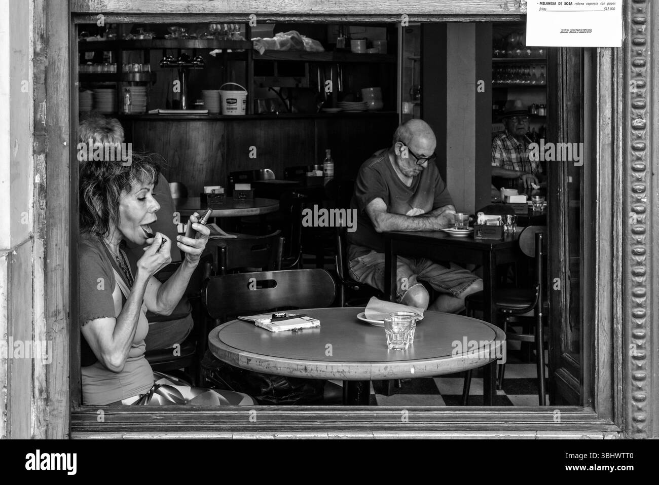 Una donna anziana che fa domanda di trucco all'interno del Bar Britanico, quartiere di San Telmo, Buenos Aires, Argentina. Foto Stock