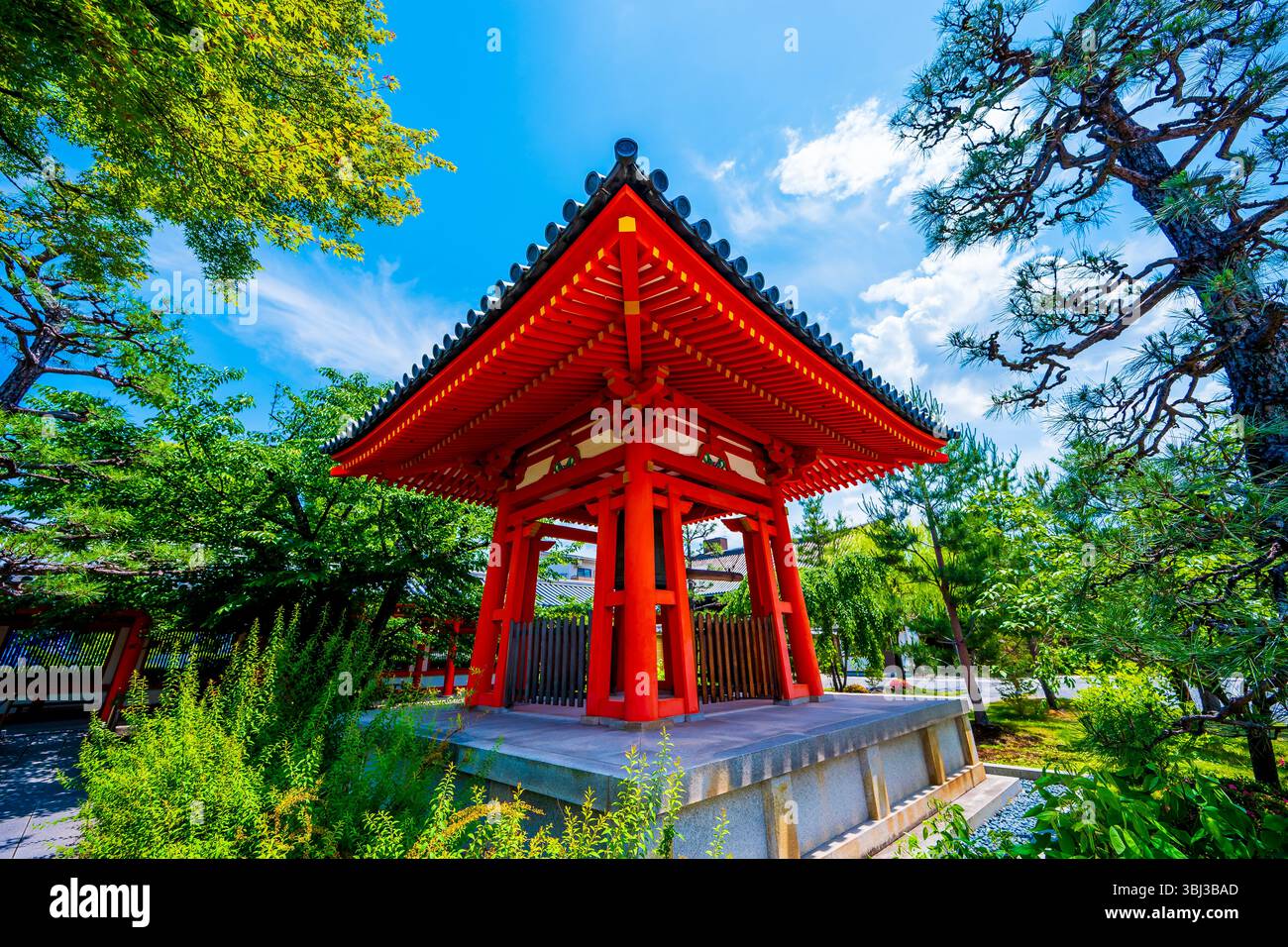 Pagoda rossa giapponese annidata nel verde lussureggiante di un tranquillo giardino di Kyoto, una storica e iconica destinazione turistica ricca di cultura e tradizione. Foto Stock